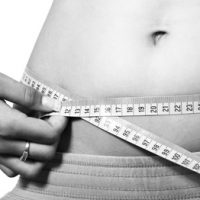 female measuring waist line