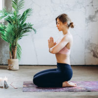 woman doing yoga and meditation / myHMB blog practicing self-care by Jennifer Dietrick