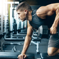 Male athlete performing bent over row at the gym