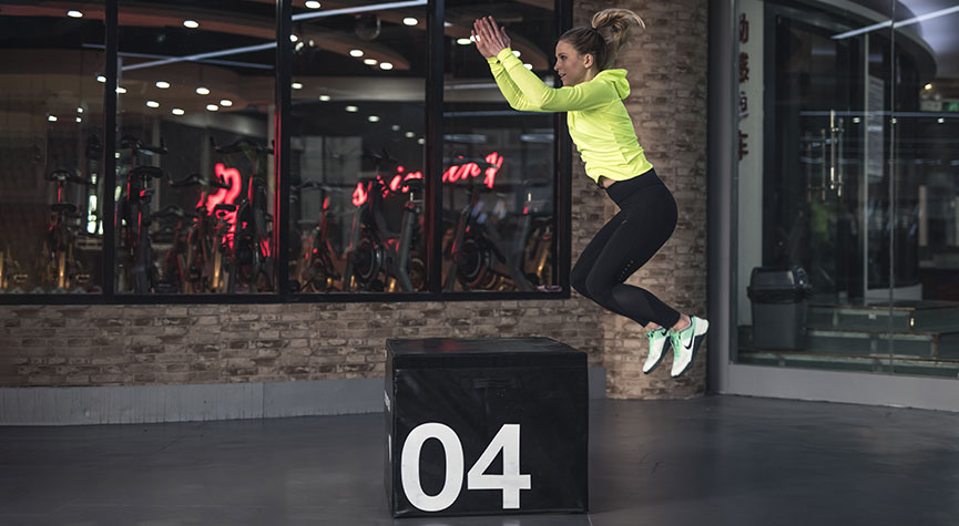 woman in a studio perfomiung box jumps