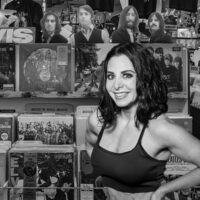 Team myHMB ambassador and fit mom Danyelle Mastarone standing in a music store