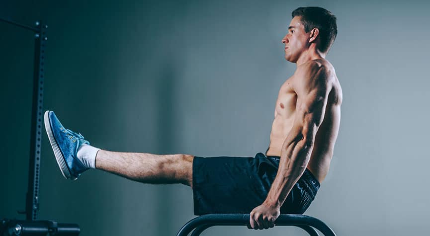 man doing an L-sit on parellette bars / myHMB blog Why You Aren’t Seeing Results from Your Workouts (Part 1)