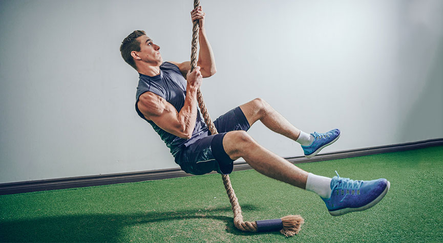 man in a gym with turf doing legless rope climbs / myHMB blog Why You Aren’t Seeing Results from Your Workouts (Part 1)