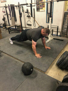 Hall of Fame powerlifter Brad Gillngham at Jackals gym performing Spiderman setup position